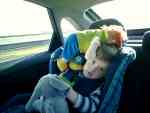 Alex in the car with Baby on his head